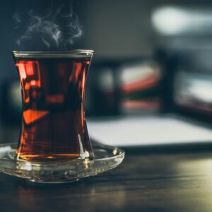 Close-up of steaming Turkish tea in a traditional glass, creating a cozy and inviting atmosphere.
